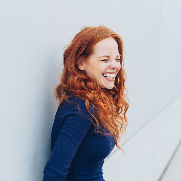Laughing young woman after successful dental implant procedure in South Ogden & Kaysville, UT