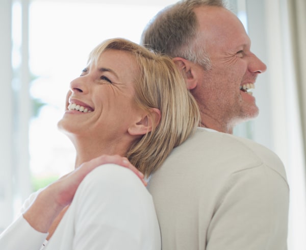 Happy elderly couple smiling after dental implants in South Ogden & Kaysville, UT, dental clinic