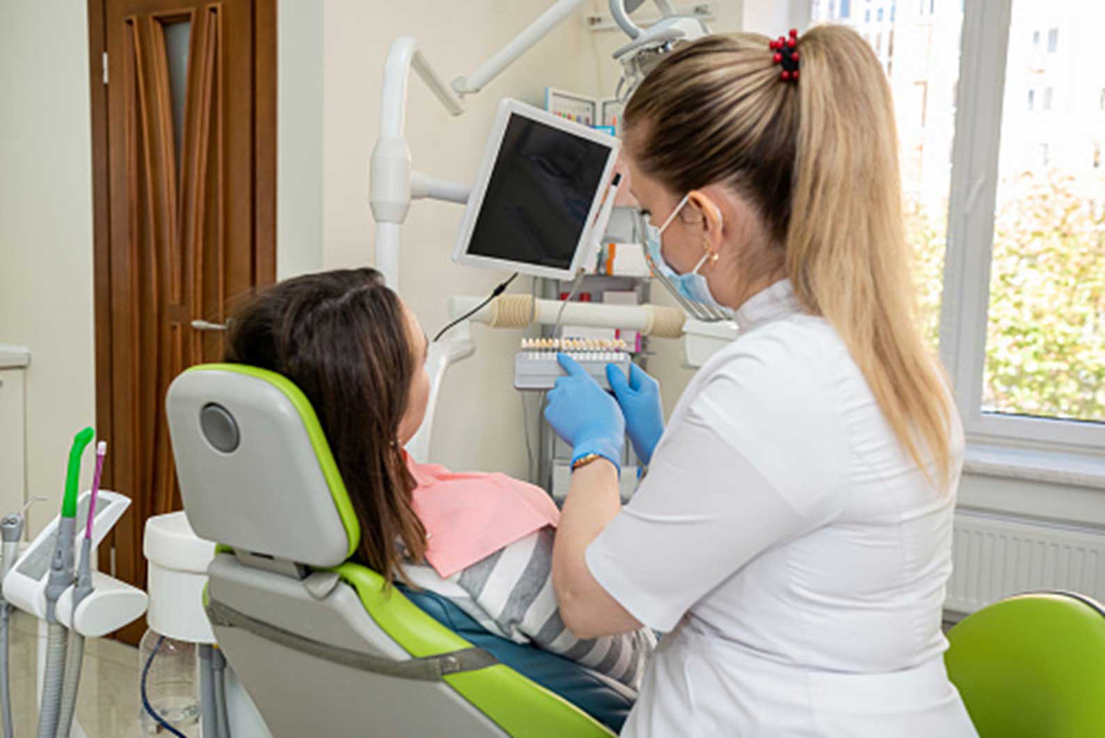 Dentist performing dental implant checkup in South Ogden & Kaysville, UT dental office