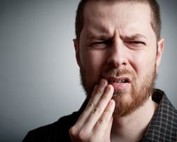 man having teeth pain