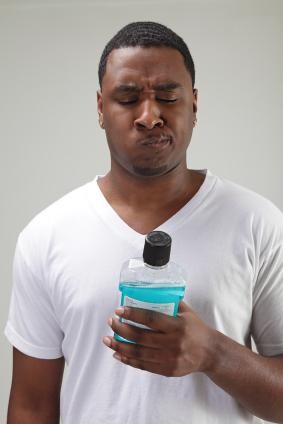 man using mouth washer