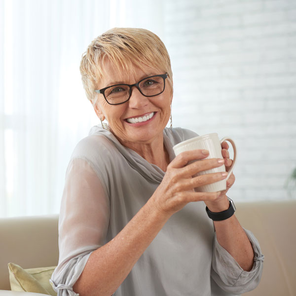 smiling middle aged woman with cup of coffee