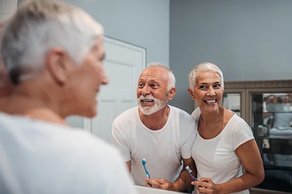 mature couple brushing teeth